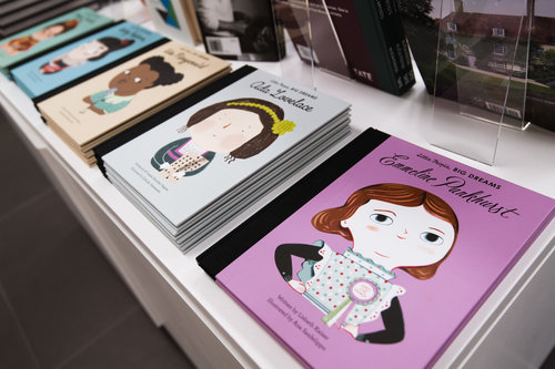 Image of illustrated books from the Little People Big Dreams series laid out on a table. Items on sale in the Glynn Vivian Art Gallery shop. Photo © Polly Thomas