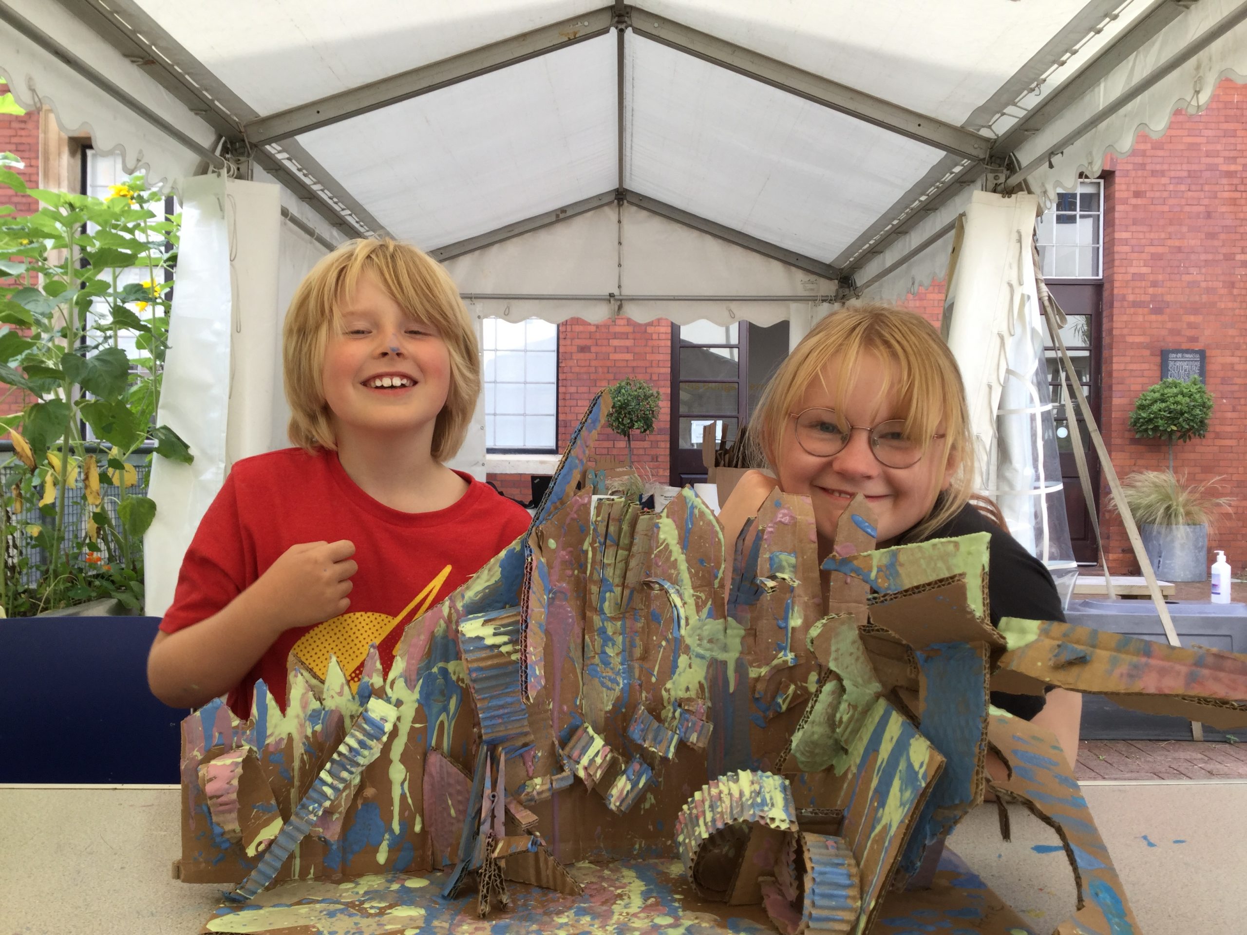 Two children making a cardboard Diorama in our Saturday Art Club workshop