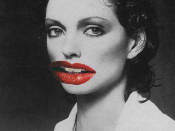 Black and white image of a female figure with bright red lips