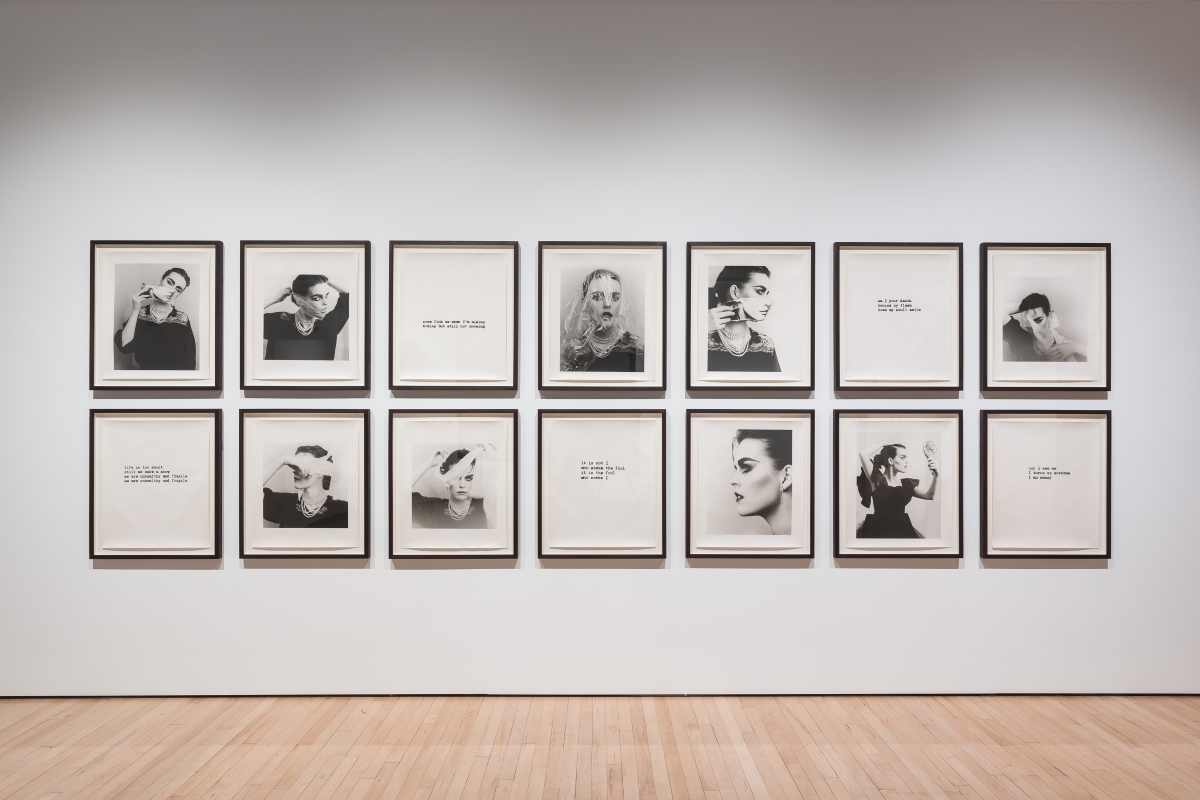 an art exhibition with black and white portraits on a wall.
